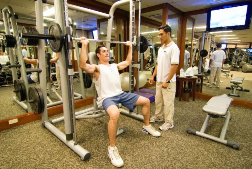 Marco Polo Davao Ξενοδοχείο Εξωτερικό φωτογραφία A personal trainer assisting a client with a weight training exercise